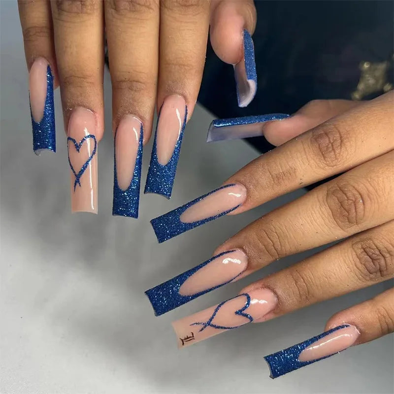 Long decorated nails with raised embellishments shown on hands