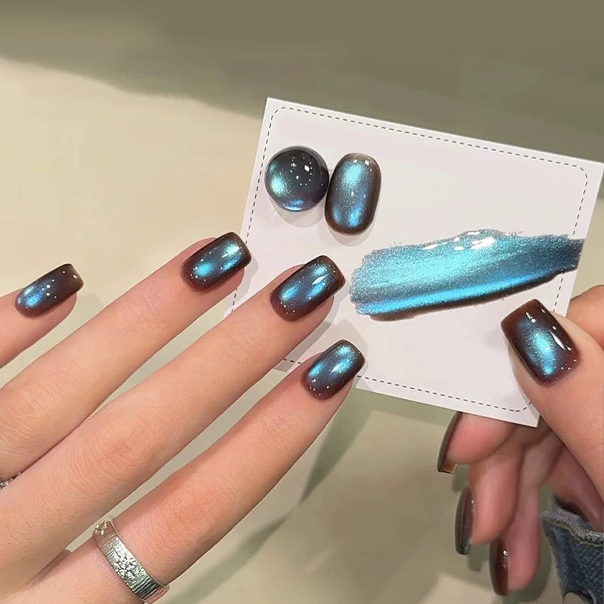 Chrome-finish nails shown on hands