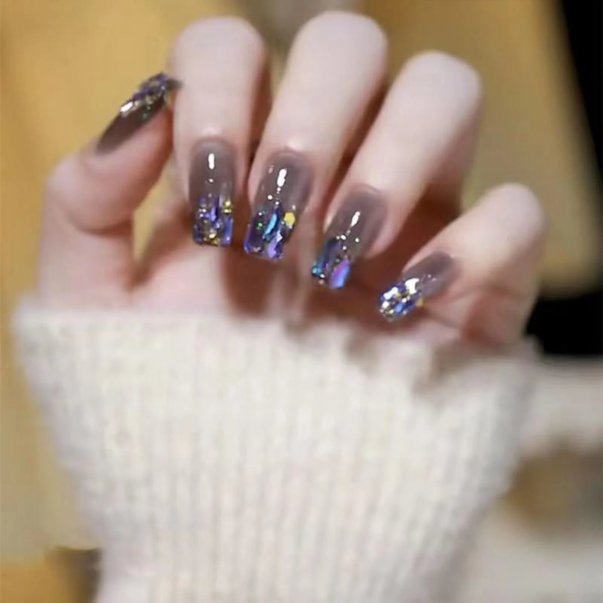 Decorated nail designs shown on hands