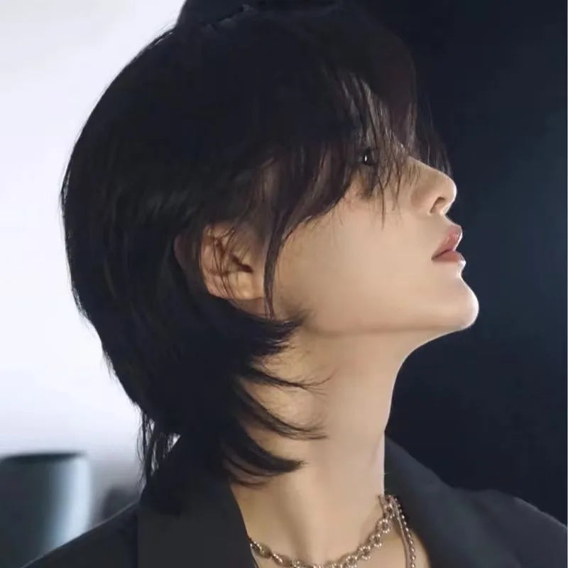 Side view of a model wearing a natural-black layered mullet wig with a long nape.
