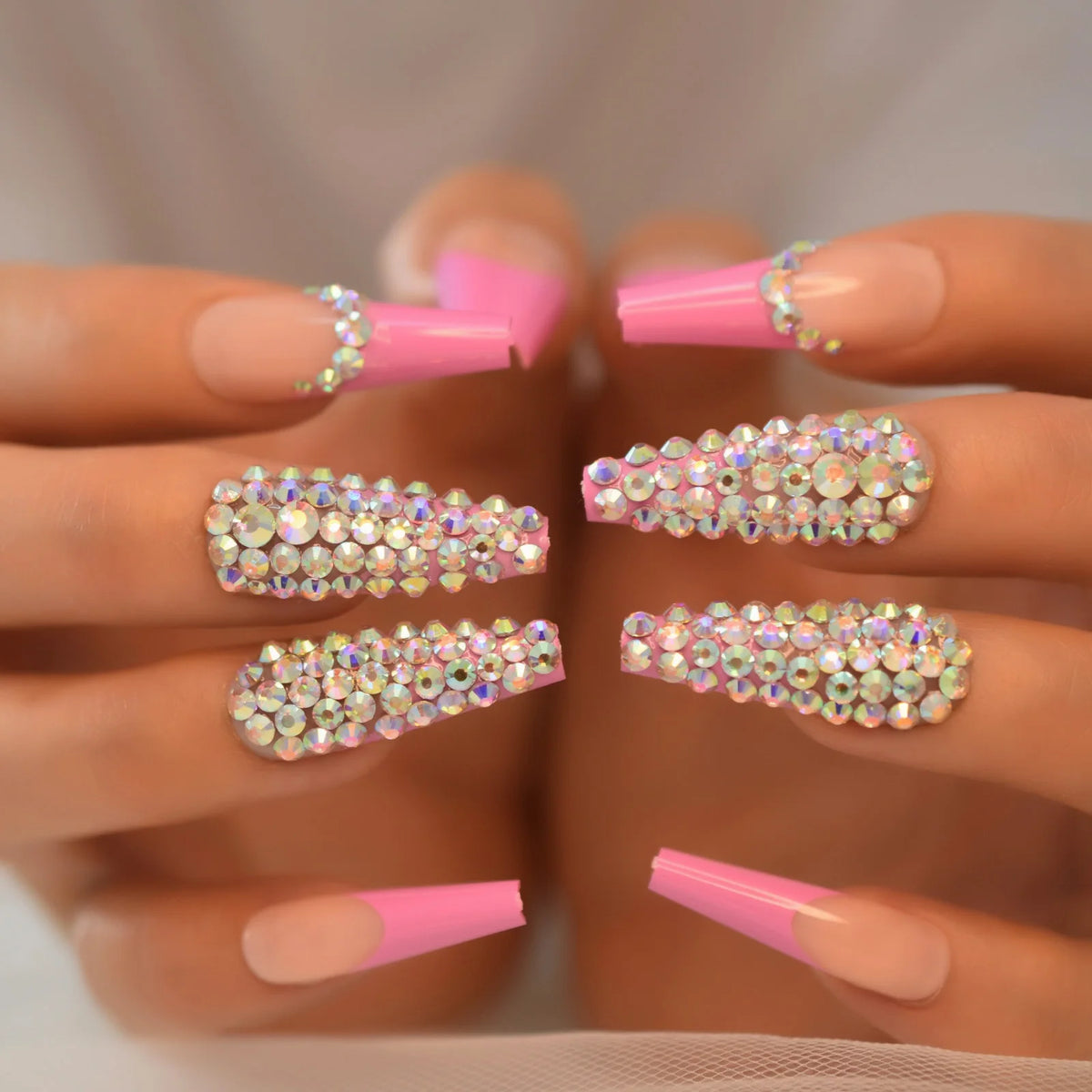 Rhinestone-decorated nail designs shown on hands