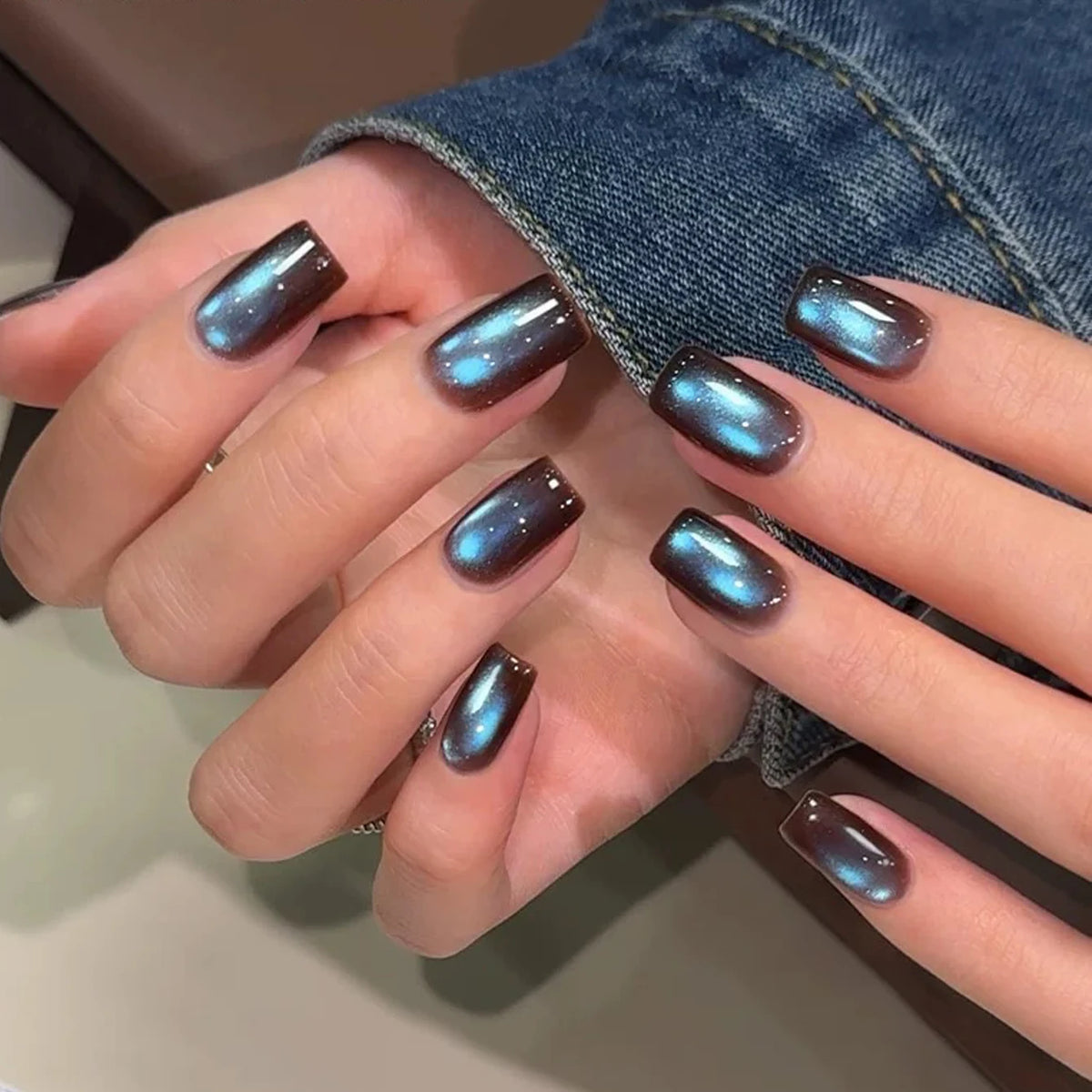 Chrome-finish nails shown on hands