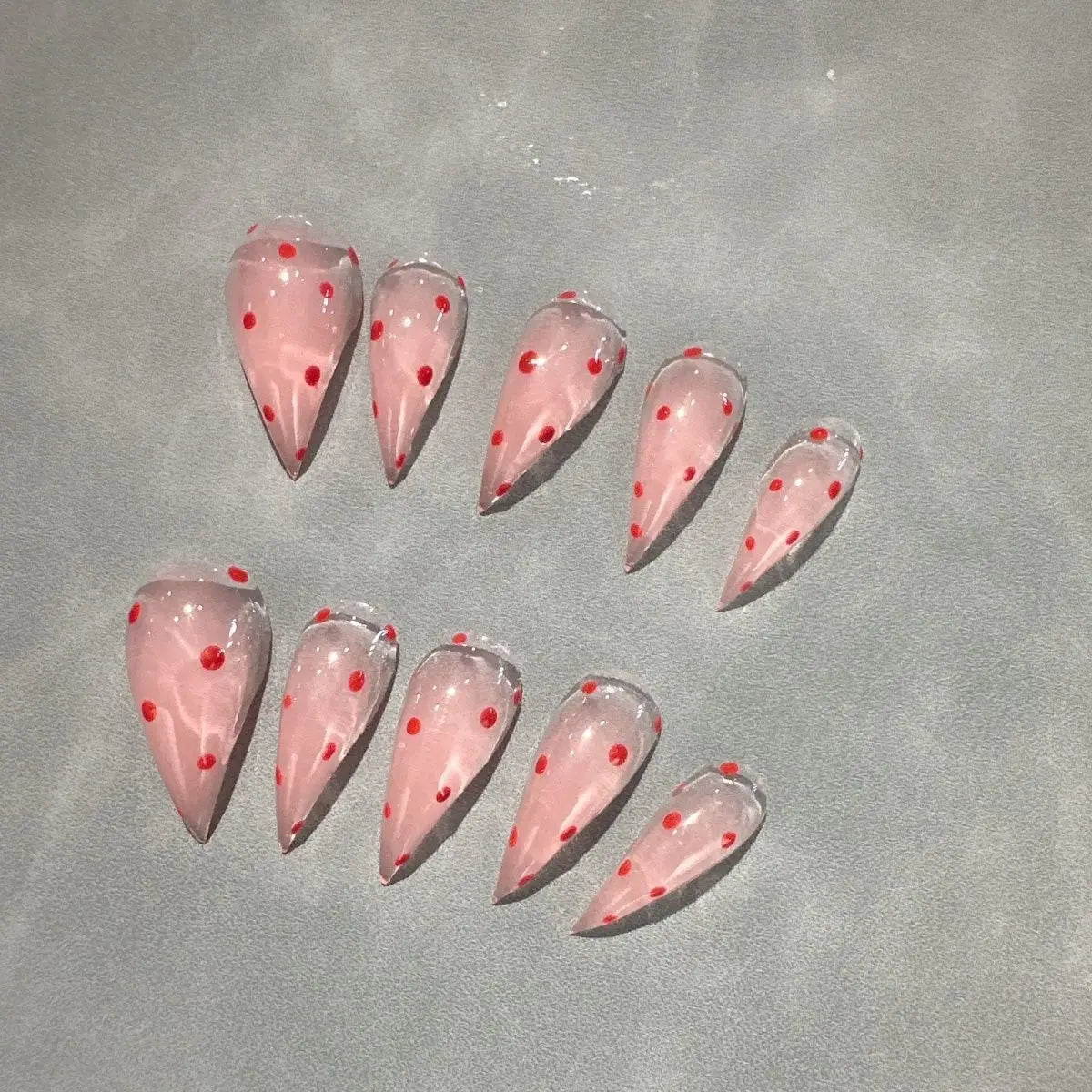 Decorated pointed press-on nails arranged in two rows