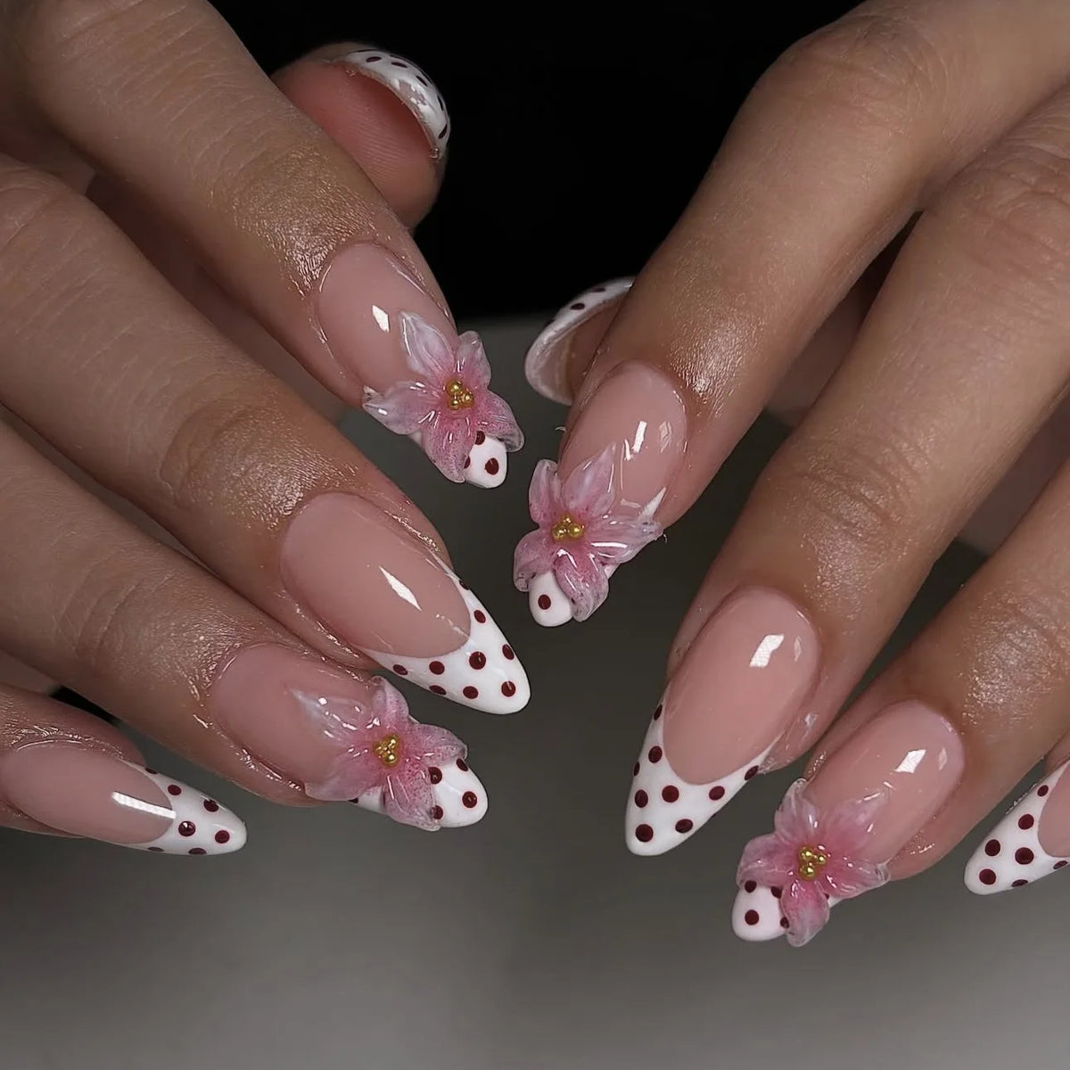 Decorated floral nails shown on hands