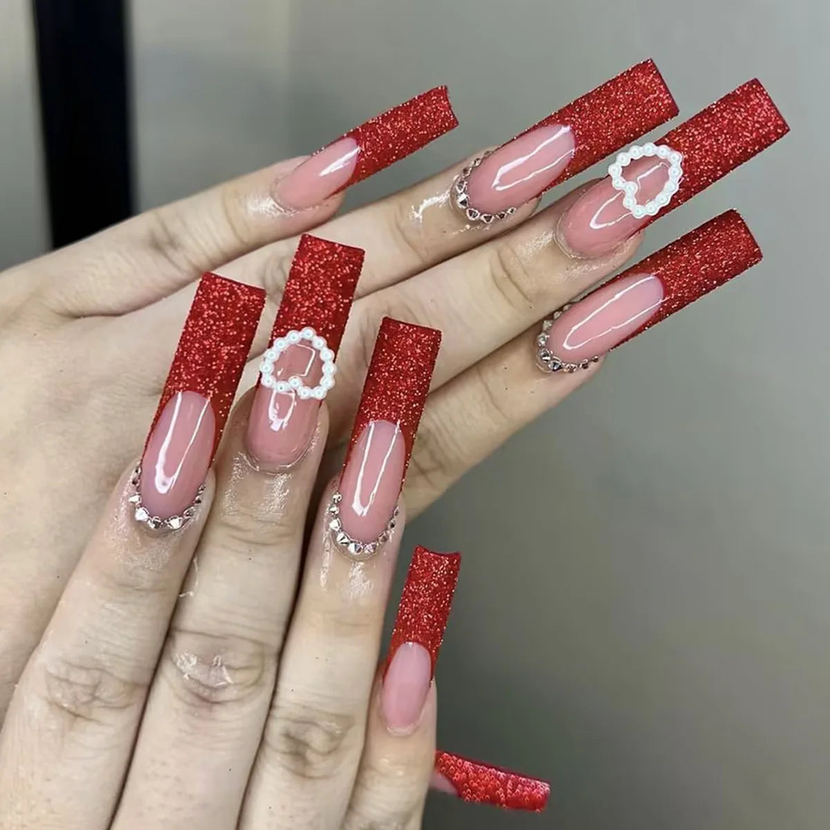 Long decorated nail designs shown on hands