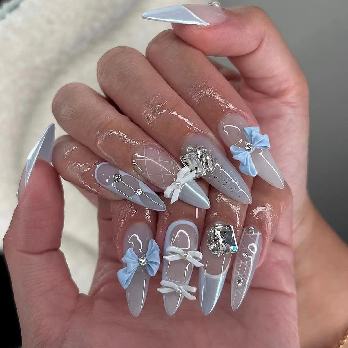 Long decorative nail designs with raised accents shown on hands