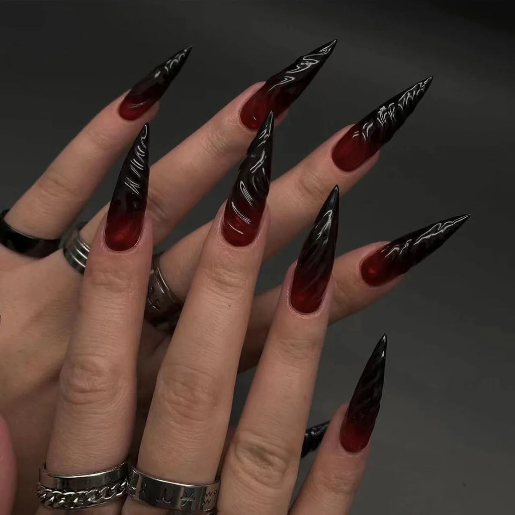 Long decorative nail designs with raised accents shown on hands