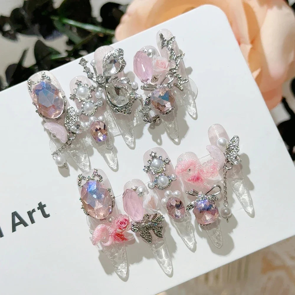 Decorated press-on nail sets with raised embellishments on display cards