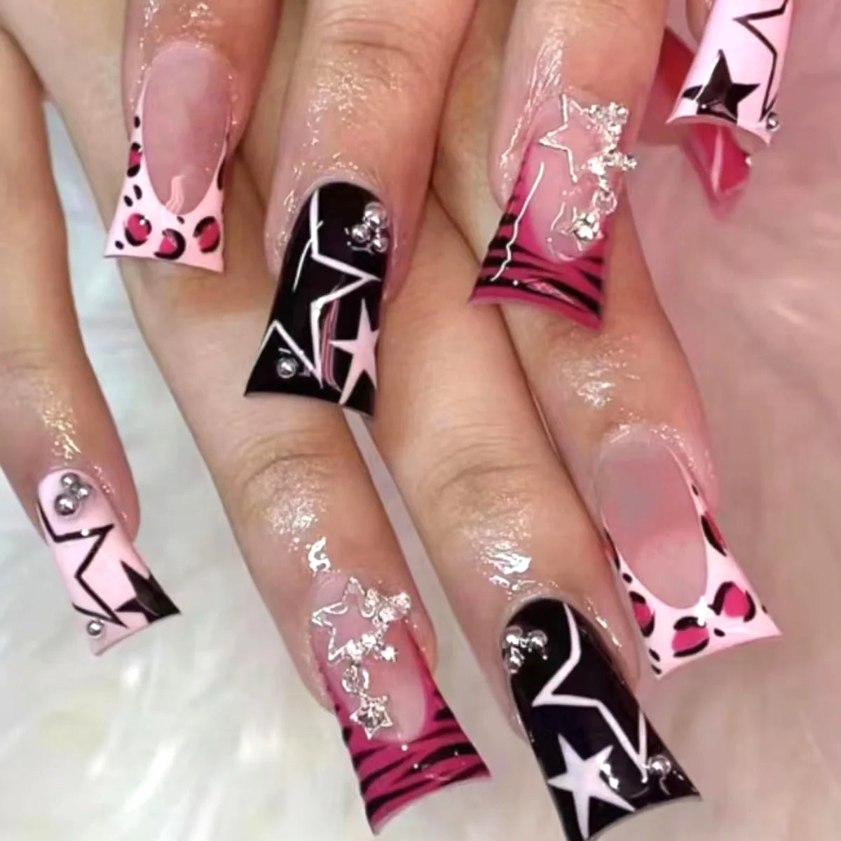 Decorative nail designs with raised accents shown on hands