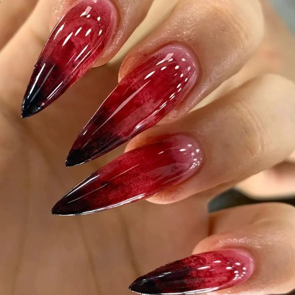 Long pointed decorative nails shown on hands