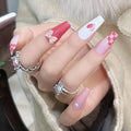 Decorated press-on nail designs shown on hands