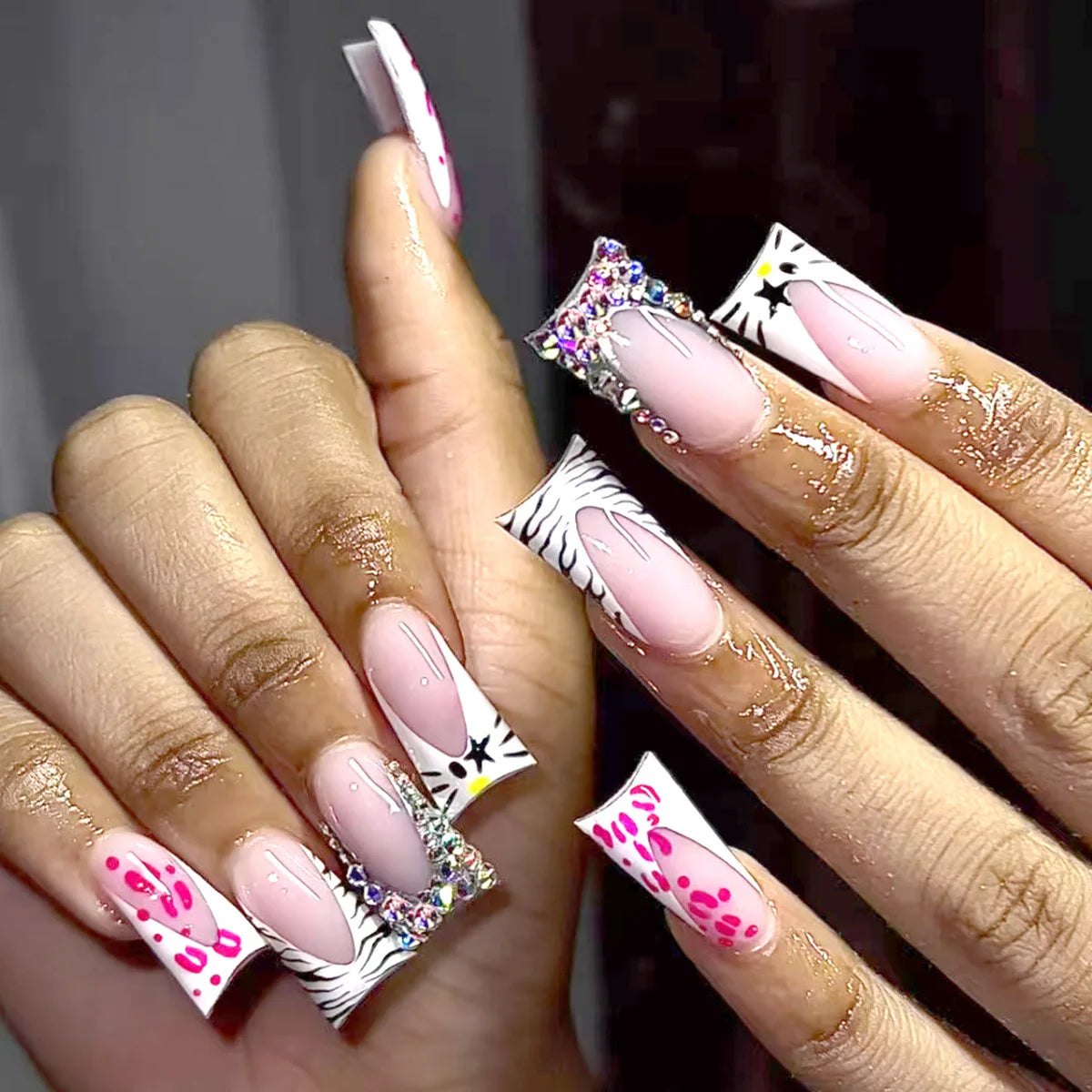 Decorative nail designs with raised accents shown on hands