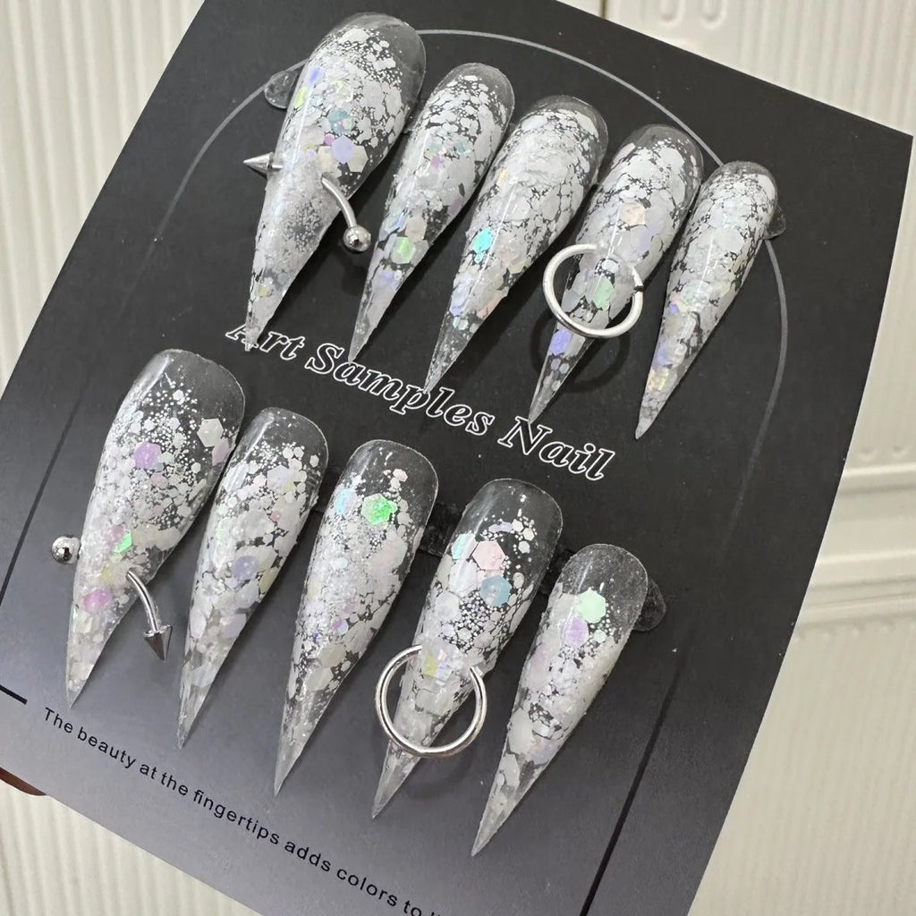 Decorated pointed press-on nails arranged in two rows
