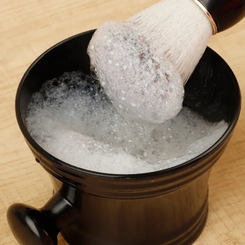 Shaving brush stirring lather in a bowl