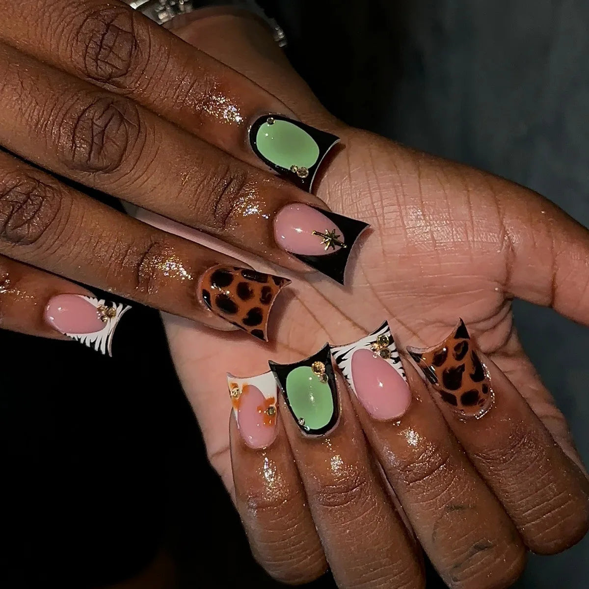 Decorative nail designs with raised accents shown on hands