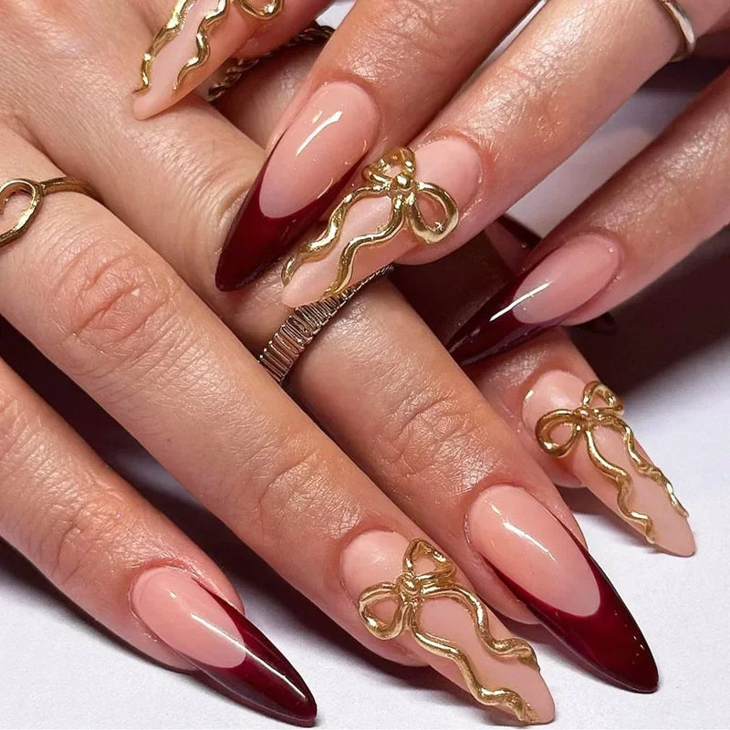 Decorated pointed nails shown on hands