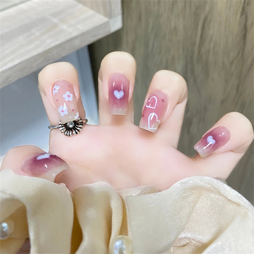 Decorated nail designs shown on hands