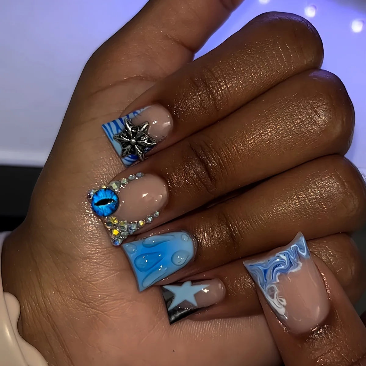 Decorative nail designs with raised accents shown on hands