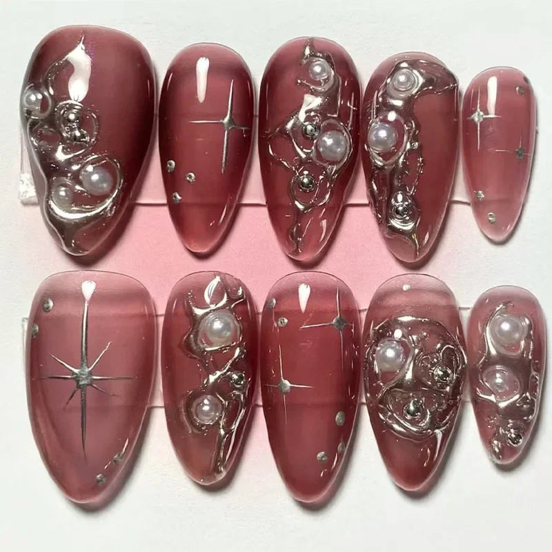 Red decorated press-on nails arranged in rows