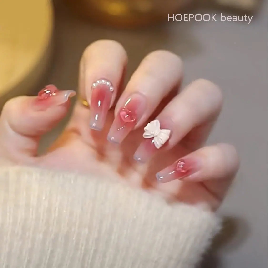 Long decorative nail designs with raised accents shown on hands