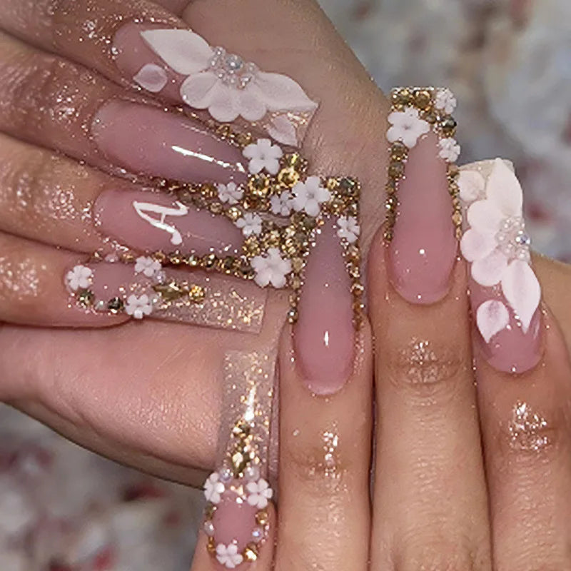 Long decorated nails with raised embellishments shown on hands