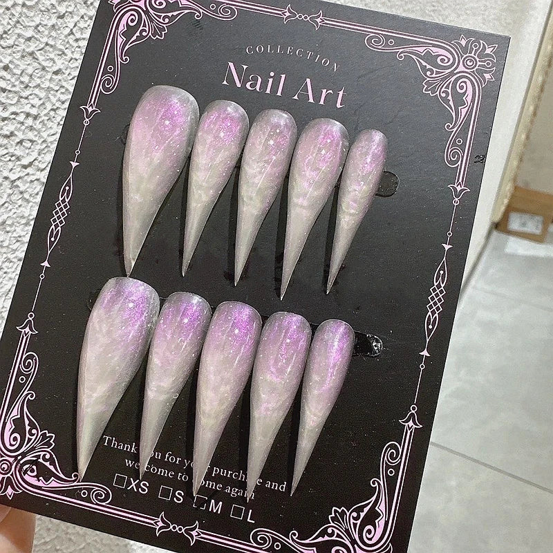 Decorated pointed press-on nails arranged in two rows