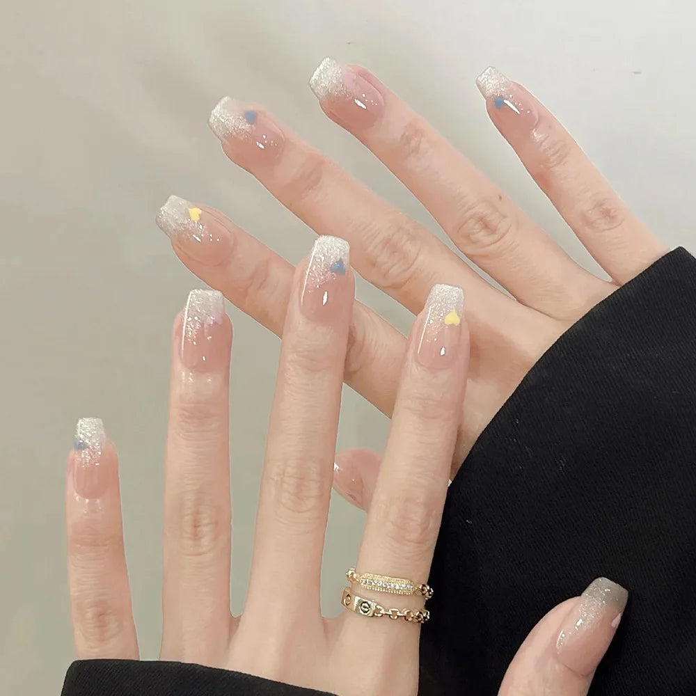 Decorated nail designs shown on hands