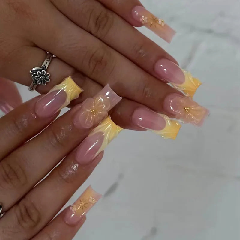 Long decorated nails with raised embellishments shown on hands