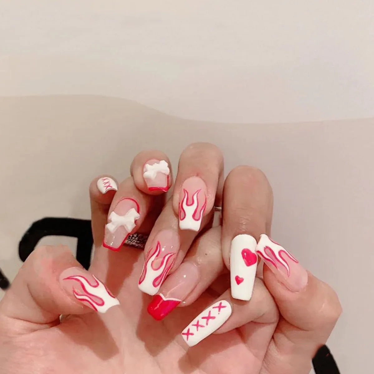 Decorated nail designs shown on hands