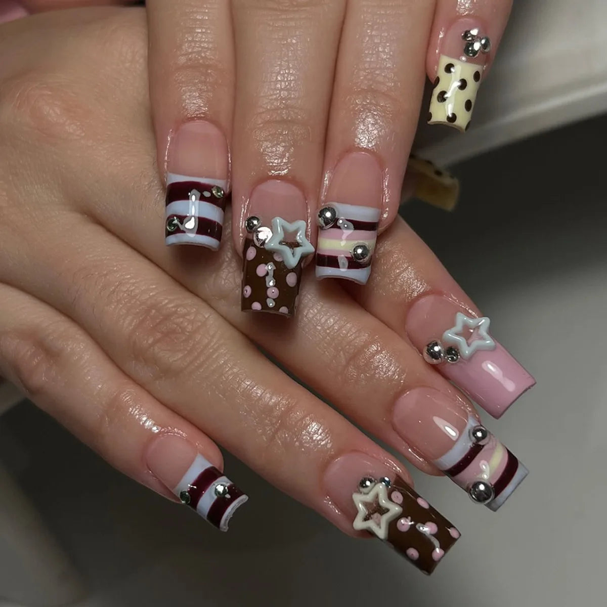 Decorated nail designs shown on hands