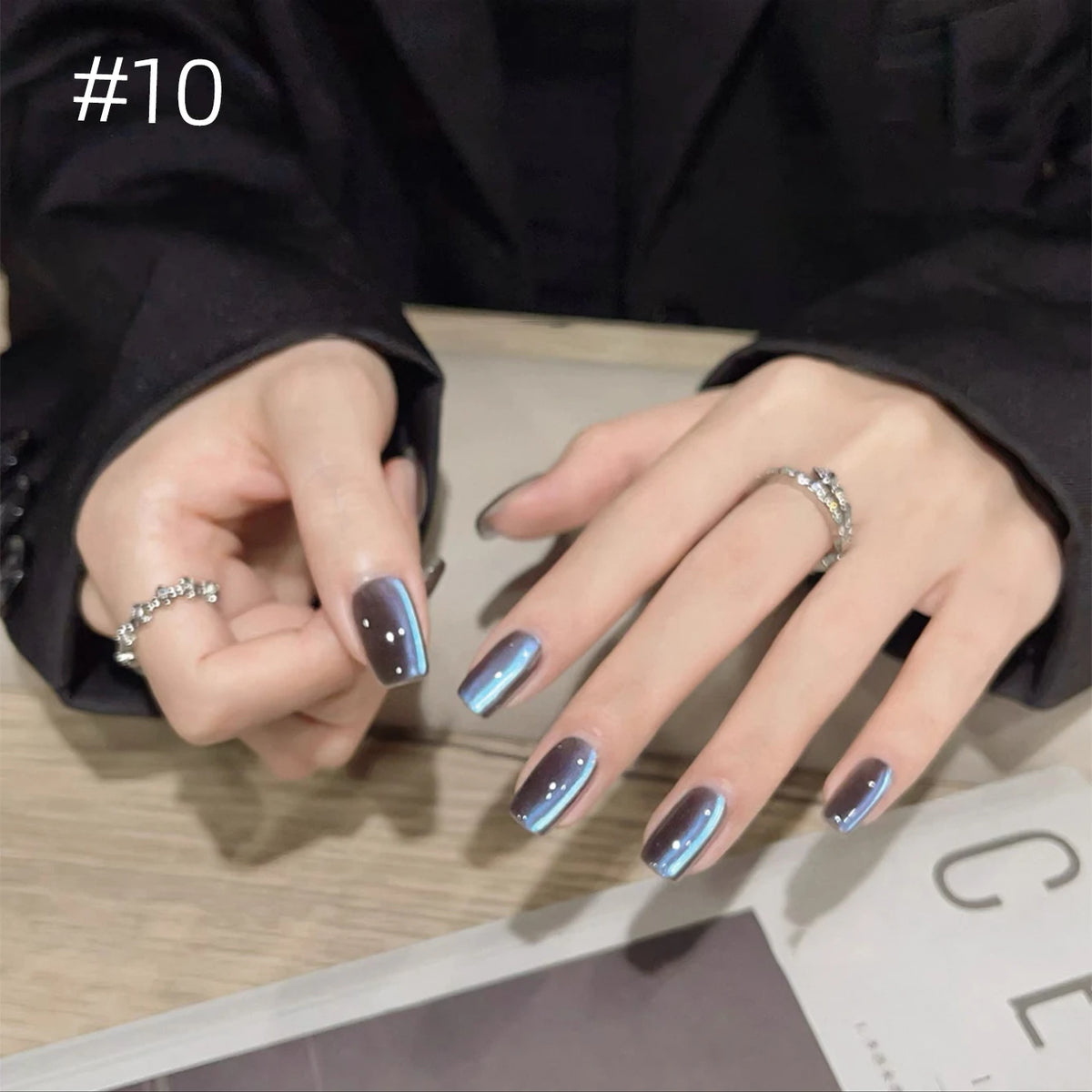 Numbered chrome nail shade shown on hands