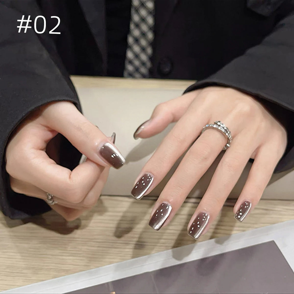 Numbered chrome nail shade shown on hands