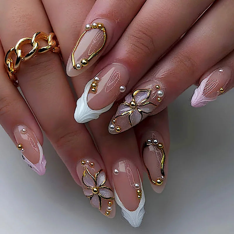Decorative floral and embellished nail designs shown on hands