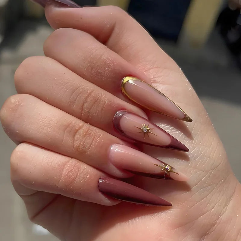 Long decorative pointed nails shown on hands