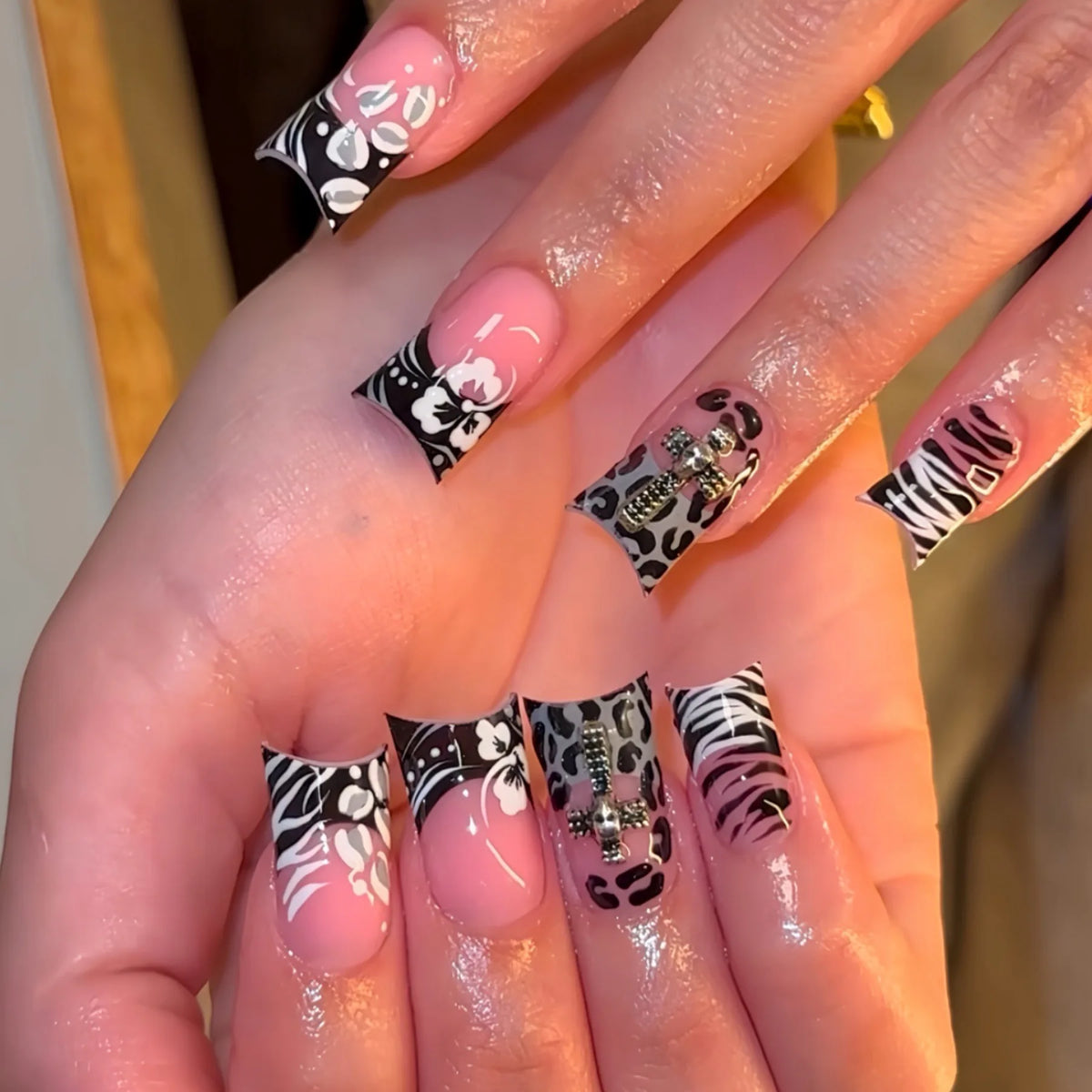 Decorative nail designs with raised accents shown on hands