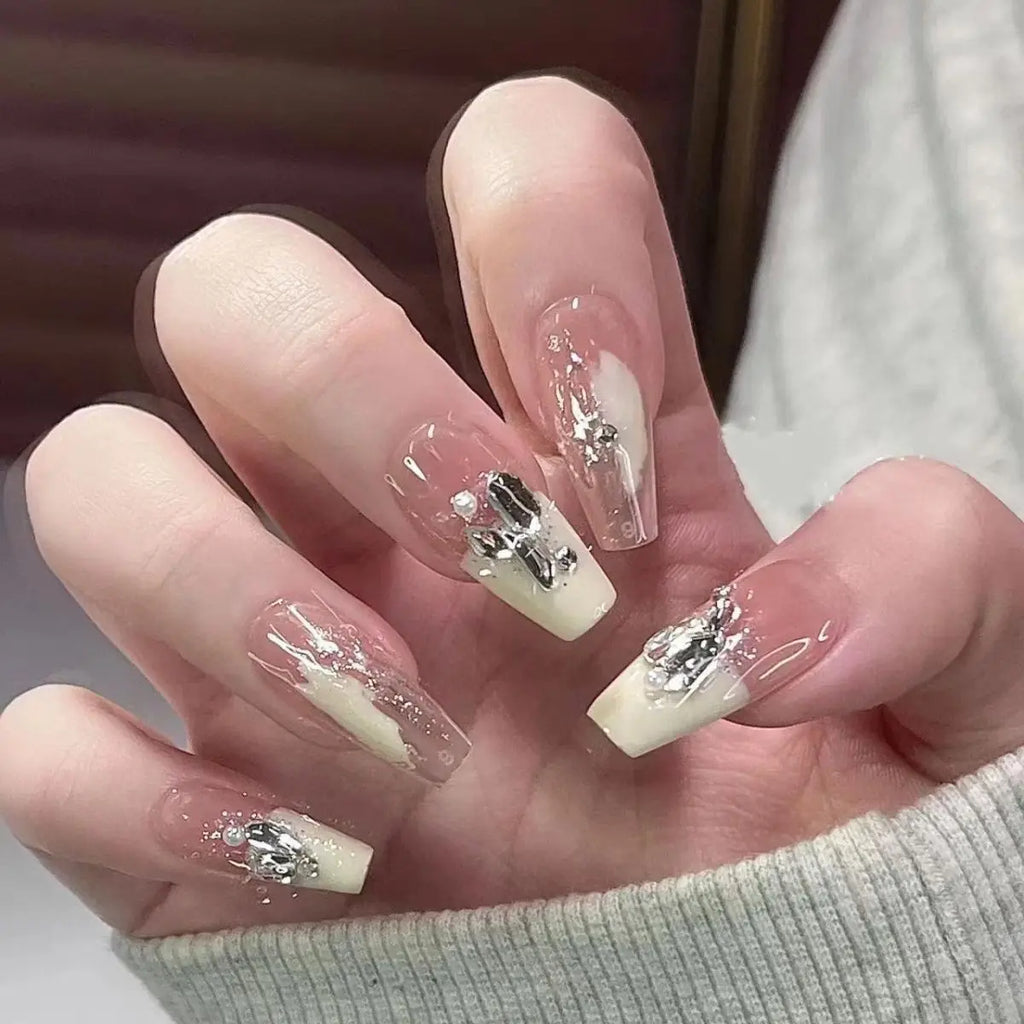 Decorated translucent nails shown on hands