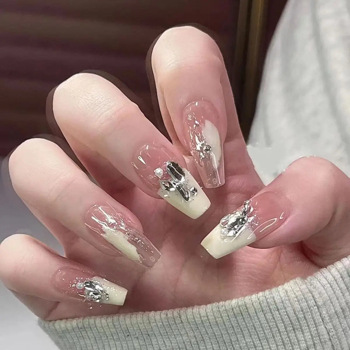 Decorated translucent nails shown on hands
