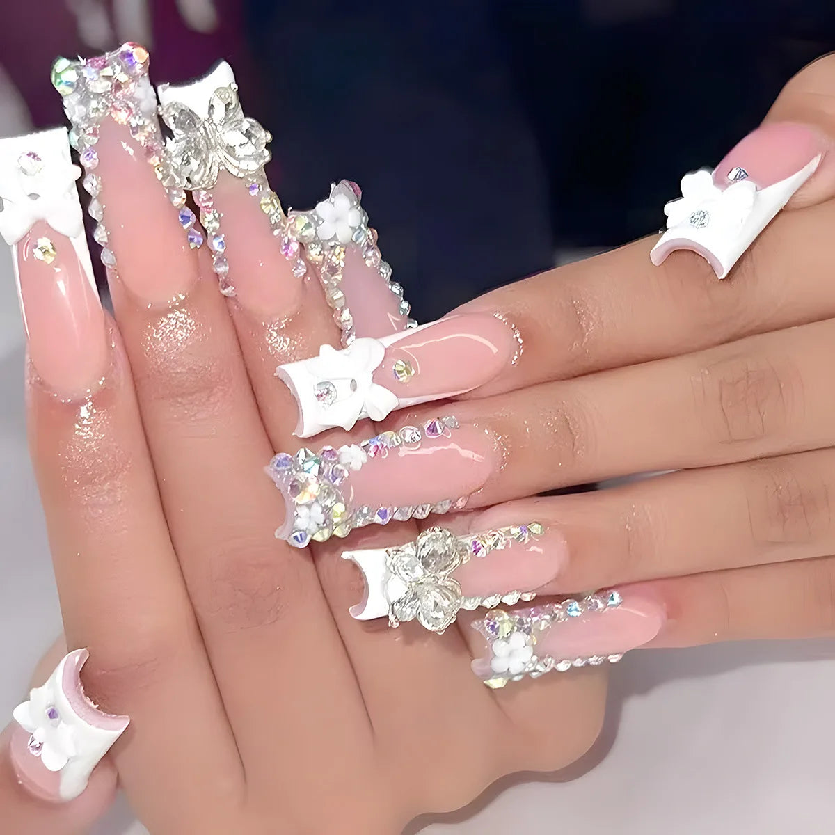 Decorated nail designs shown on hands