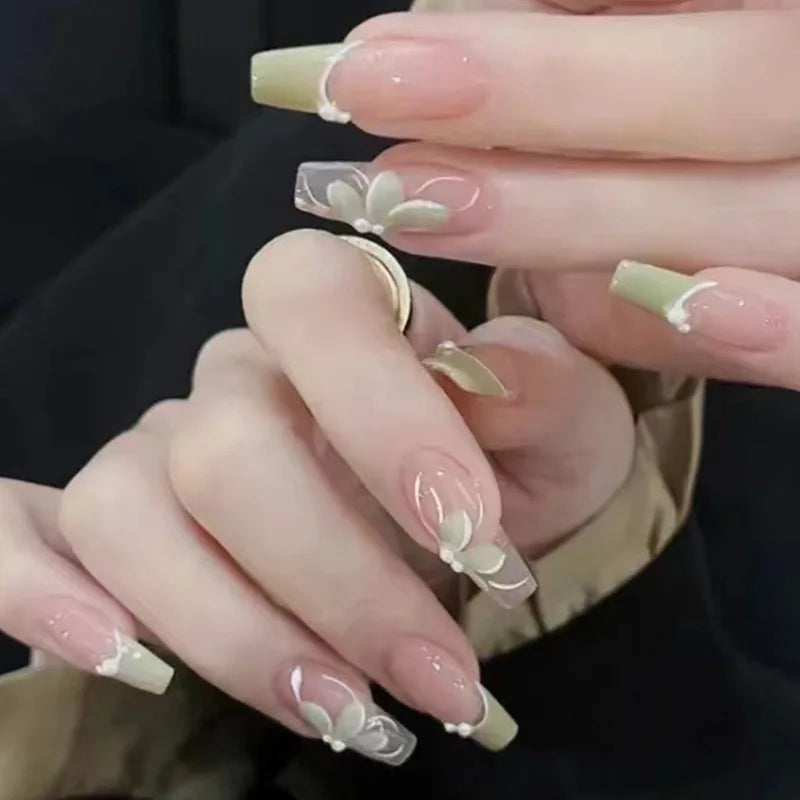 Long decorative nail designs with raised accents shown on hands
