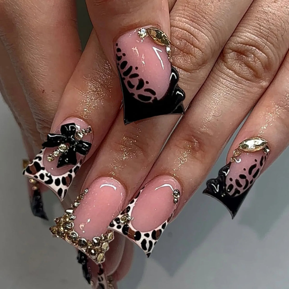 Decorative nail designs with raised accents shown on hands