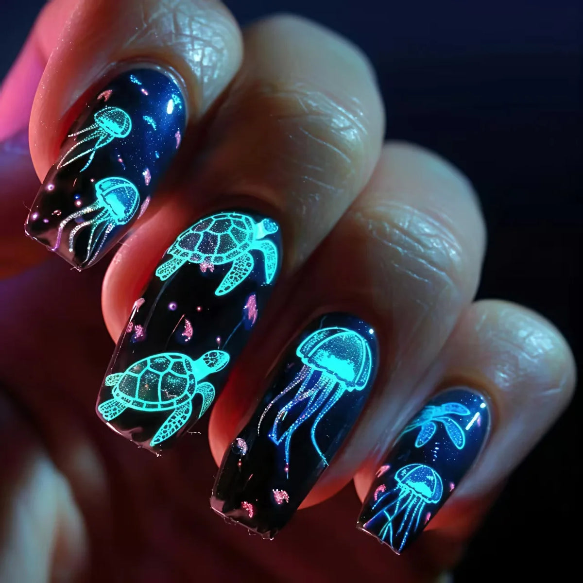 Colorful marine-themed nail artwork shown on hands