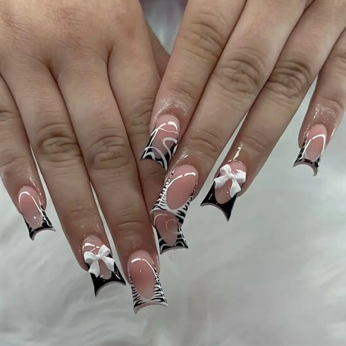 Decorative nail designs with raised accents shown on hands