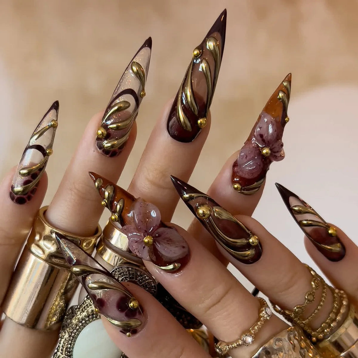 Long decorative nail designs with raised embellishments shown on hands