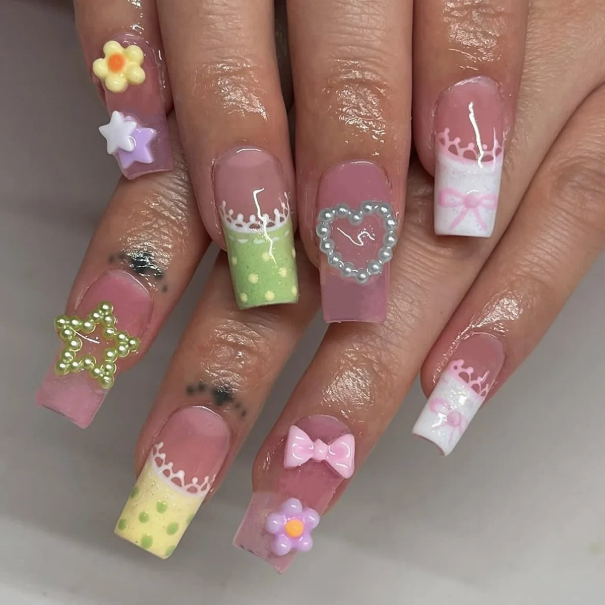 Decorated nail designs shown on hands