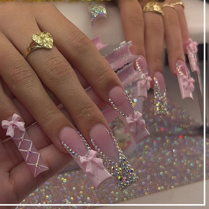 Long decorated nail designs shown on hands