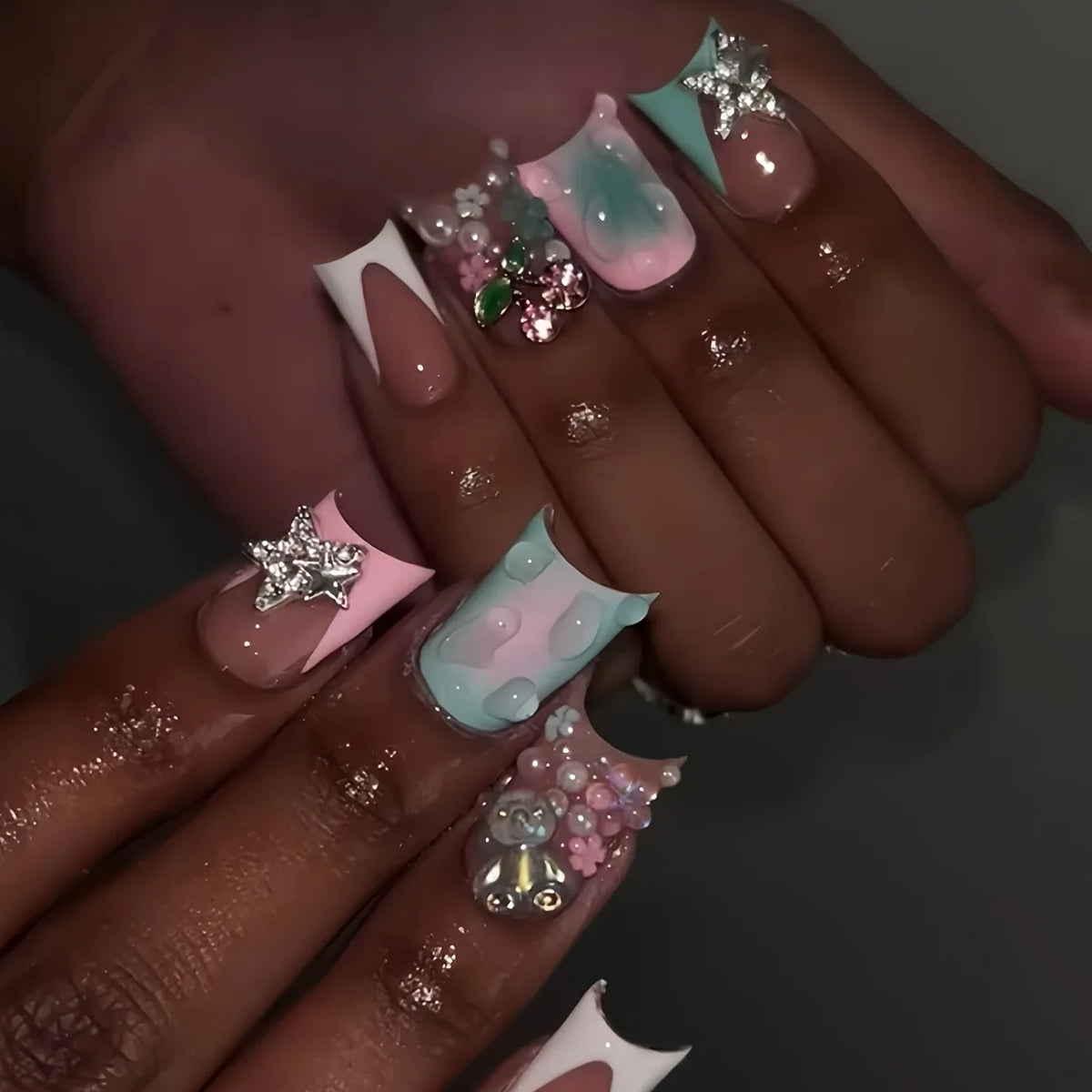 Decorative nail designs with raised accents shown on hands