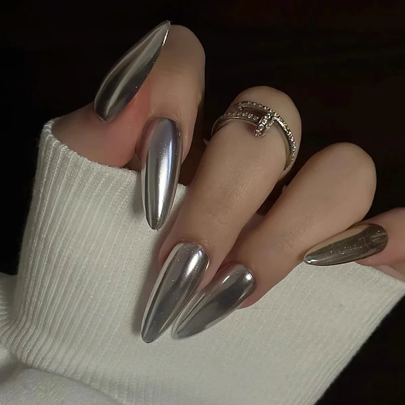 Metallic pointed nails shown on a hand