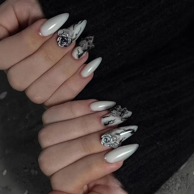 Long decorative nail designs with raised accents shown on hands