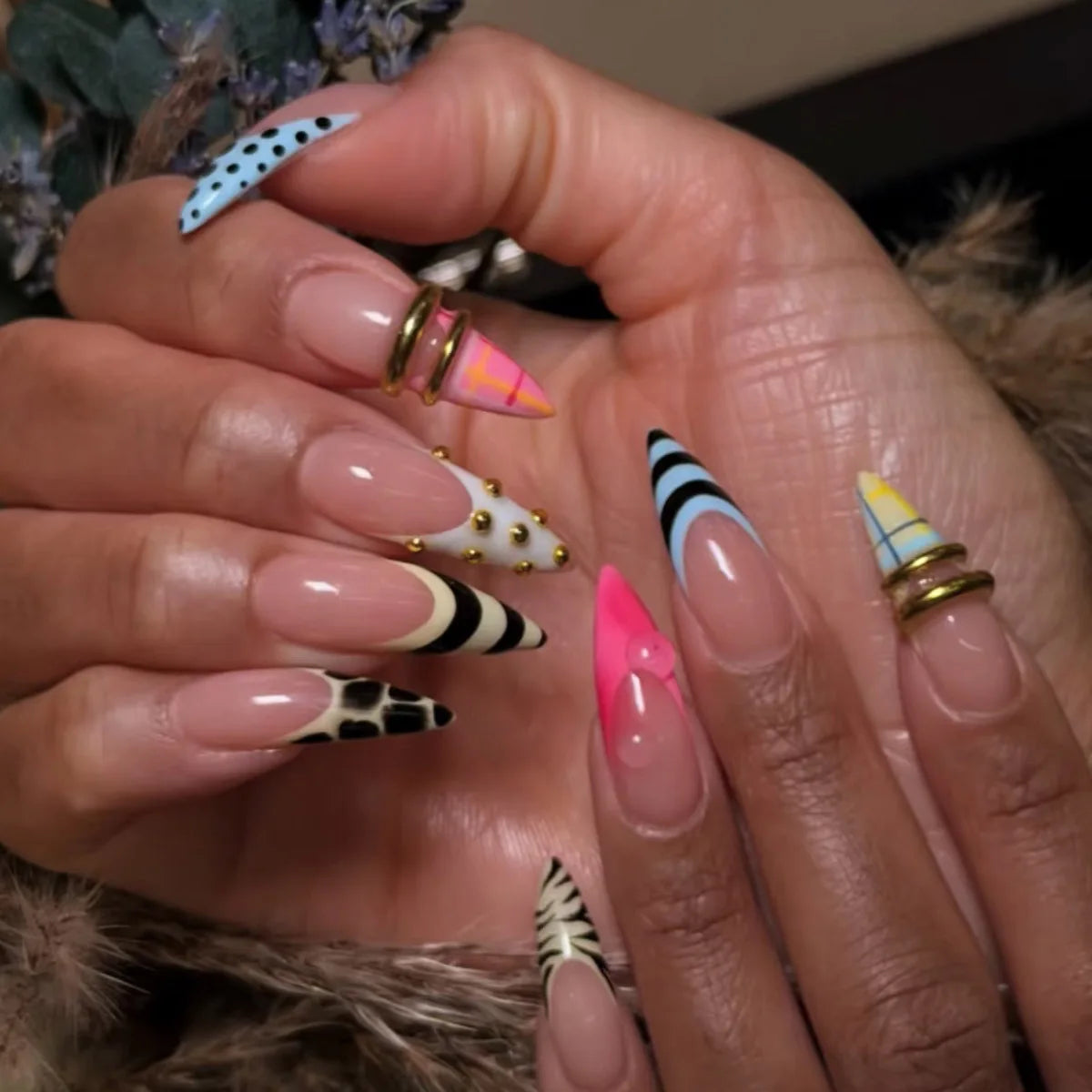 Long decorative pointed nails shown on hands