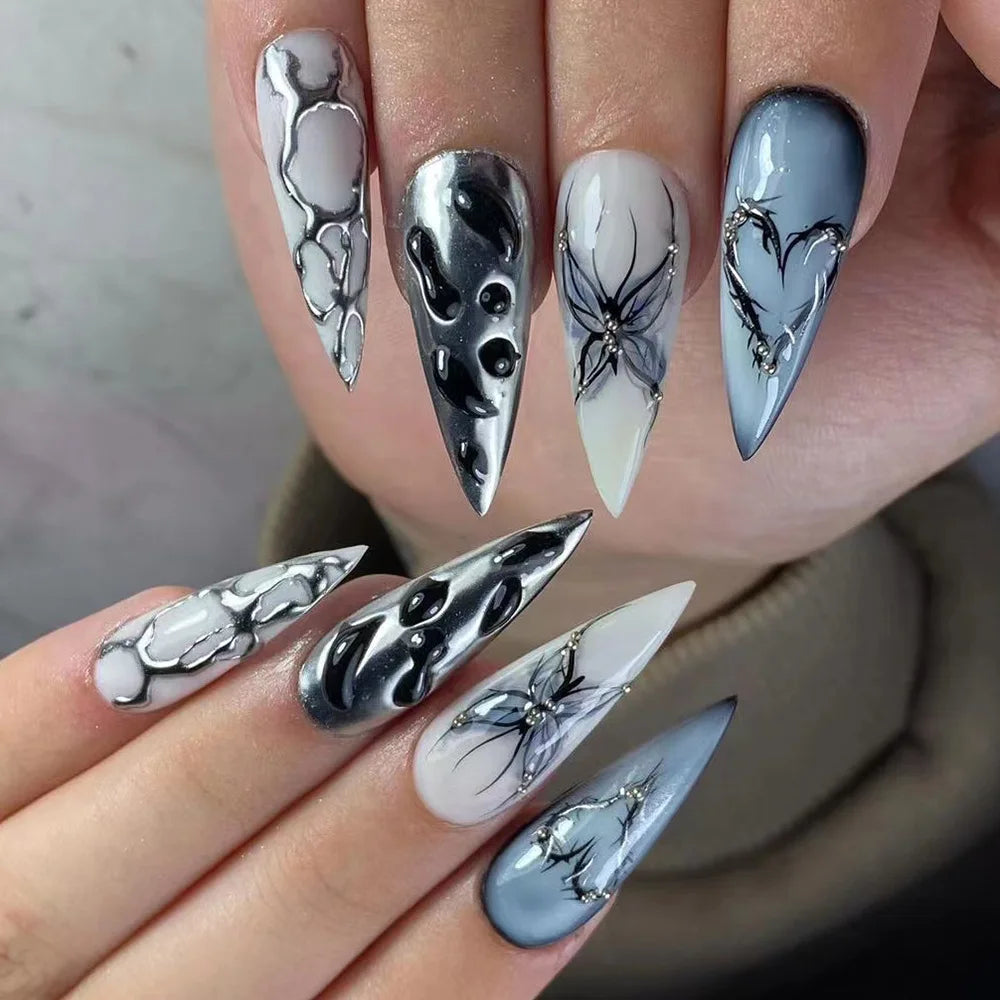 Long decorative nail designs with raised accents shown on hands